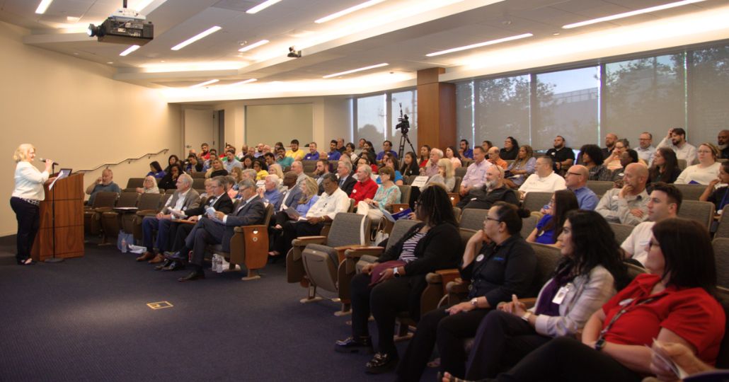 group of people sitting in an auditorium