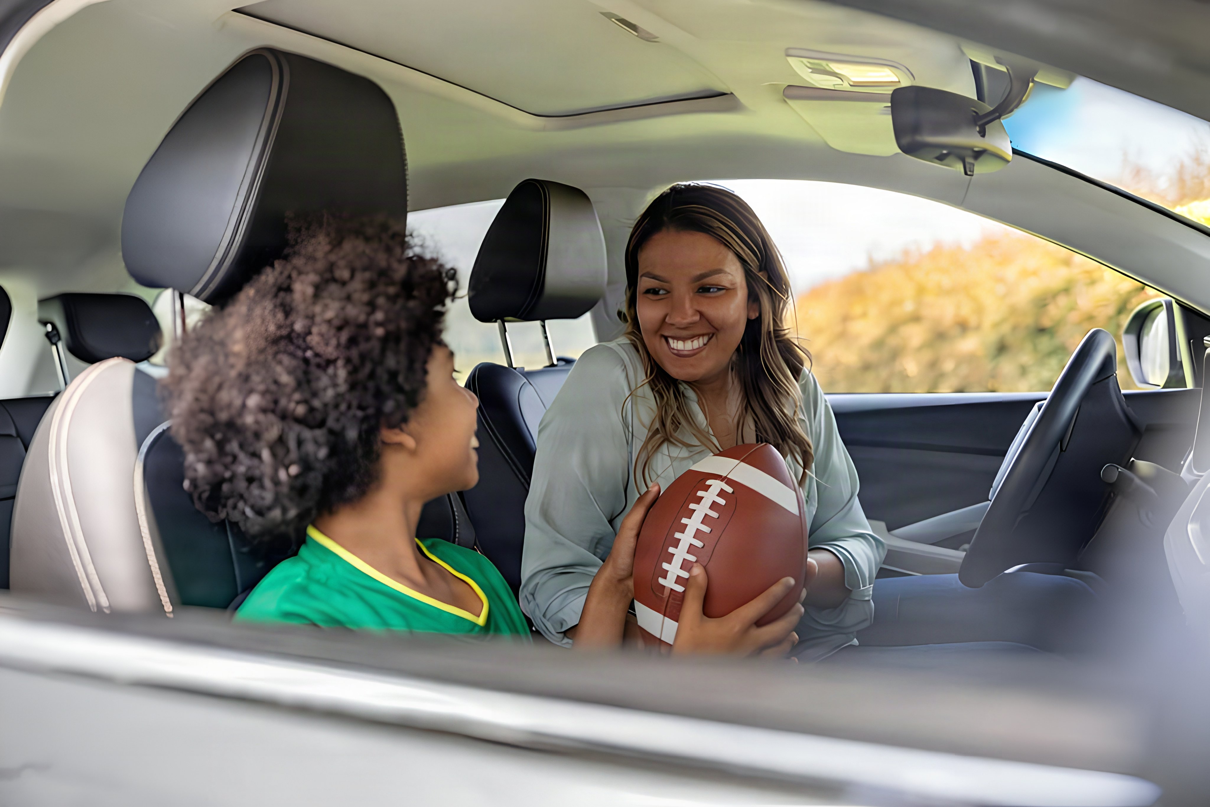 a boy and mother driving to football practice