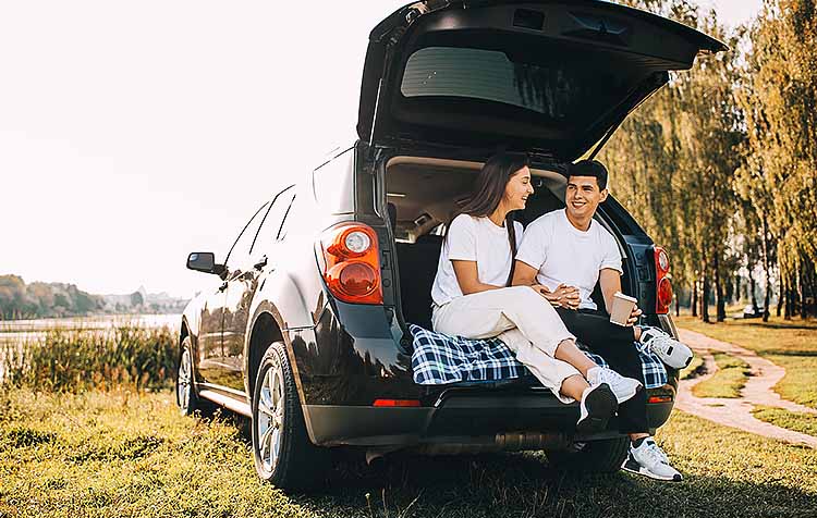 People sitting in trunk of car