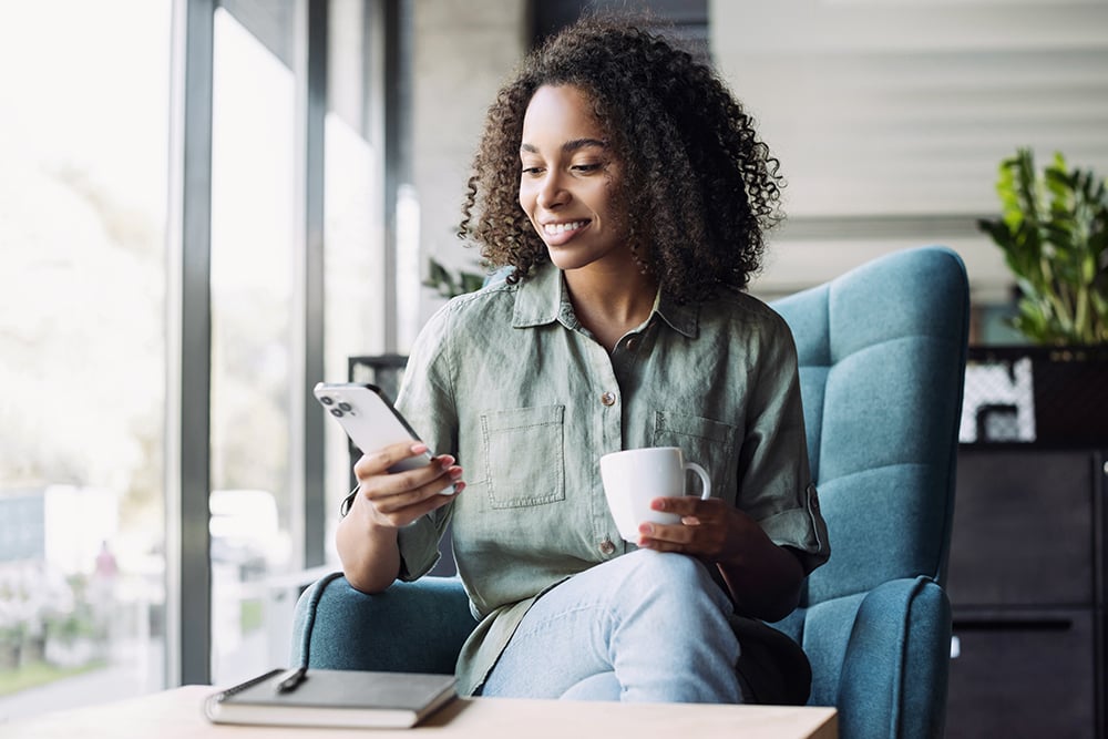 woman using phone at cafe