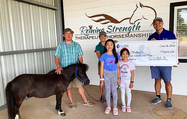 charity holding large check 