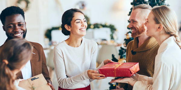 friends exchanging gifts during the holidays