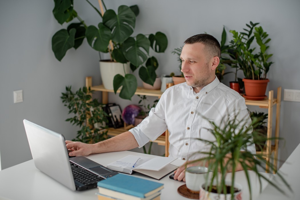 man on laptop managing finances