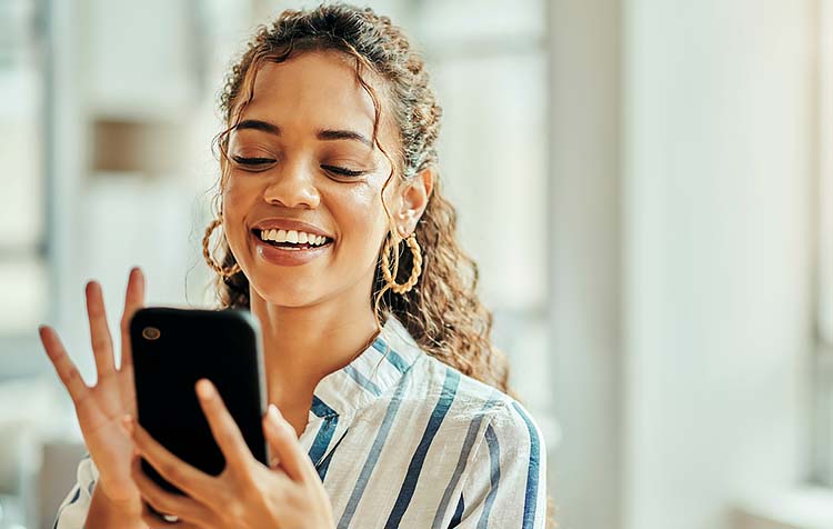 A girl smiling at her phone