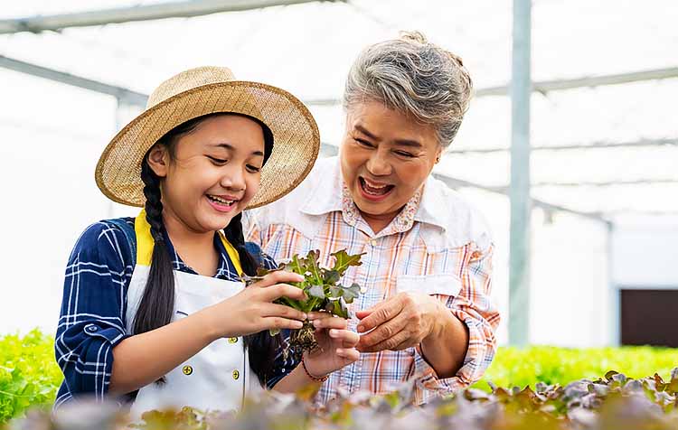 Grandmother and granddaughter looking at plants at a nursery